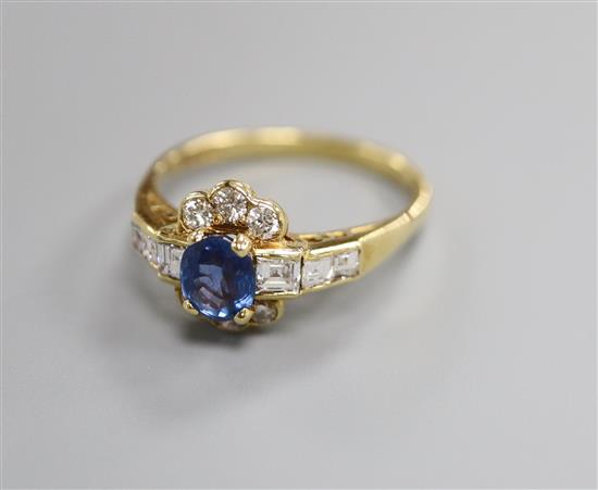 A modern 18ct gold, sapphire, round and square cut diamond set cluster ring, with diamond set shoulders, size L/M.